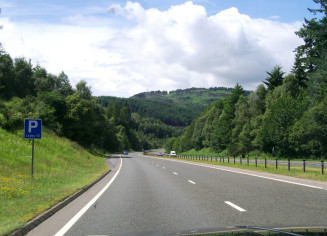 Motorway and mountains in Scotland, seen through Jeep windscreen.